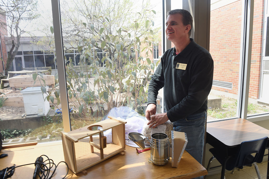 Mike Szydlowski prepares a smoker to calm the bees
